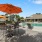 a patio with tables and chairs and umbrellas
