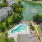 a pool surrounded by buildings and trees