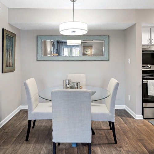 Refined spaces to match your style a kitchen with a dining table and chairs