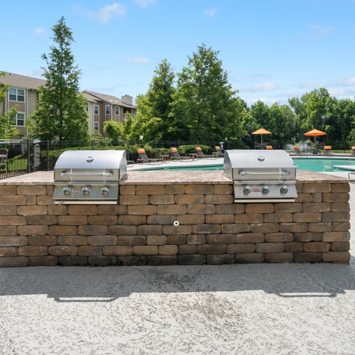 The essence of exceptional living outdoor grilling area next to the pool
